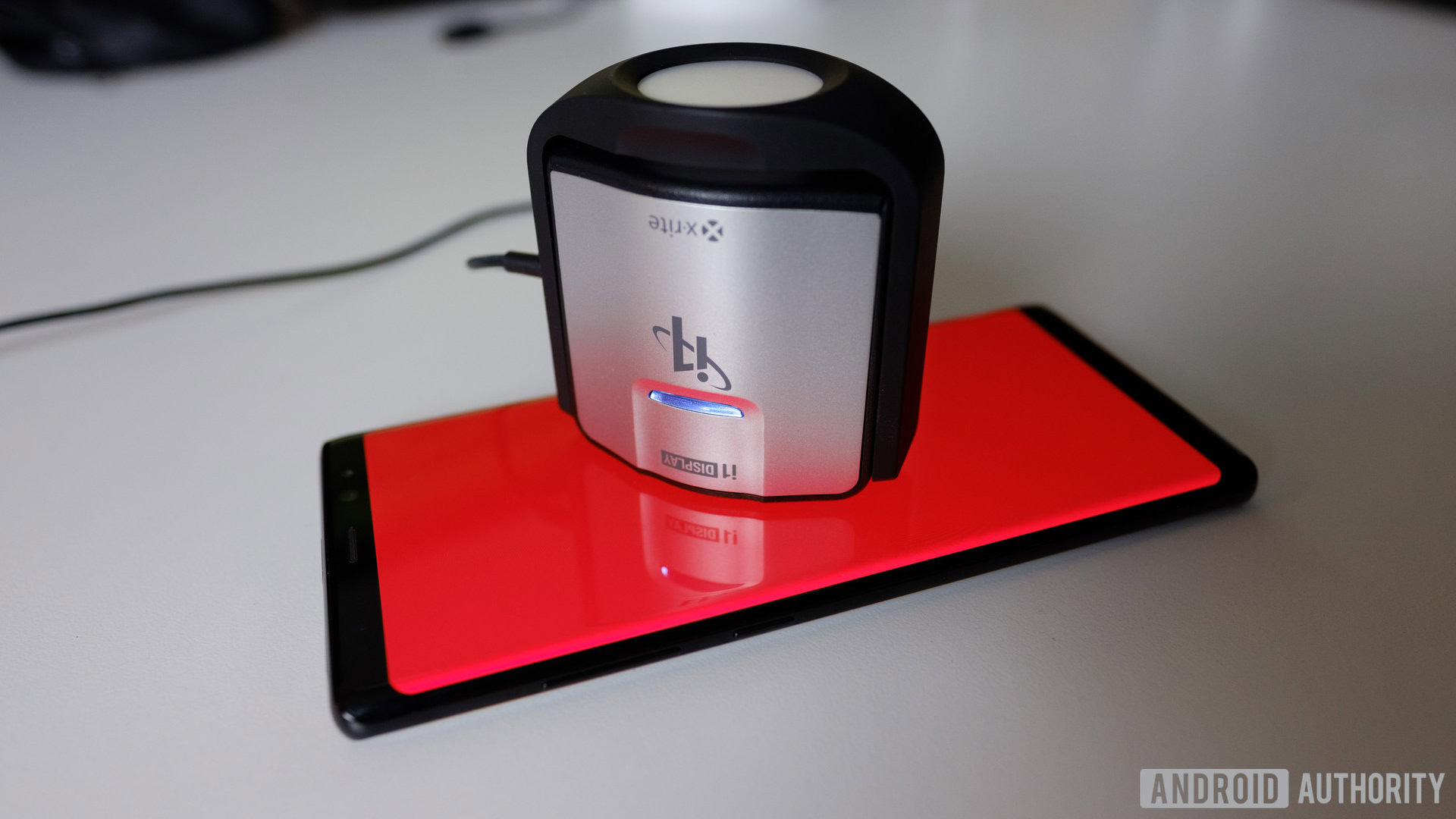 How we test displays A photo of a smartphone being tested with a spectrophotometer.