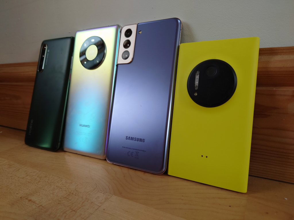 Sony Xperia 1 II camera indoor underexposed shot of a lineup of devices on a table.