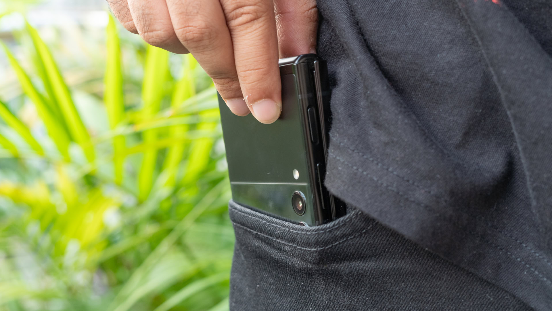 Samsung Galaxy Z Flip 3 slliding phone into pocket Samsung Galaxy Z Flip 3 slliding phone into pocket