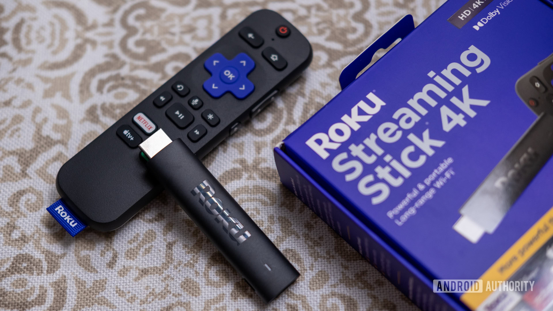 roku streaming stick 4k next to box A Rroku Streaming Stick 4K next to its box.