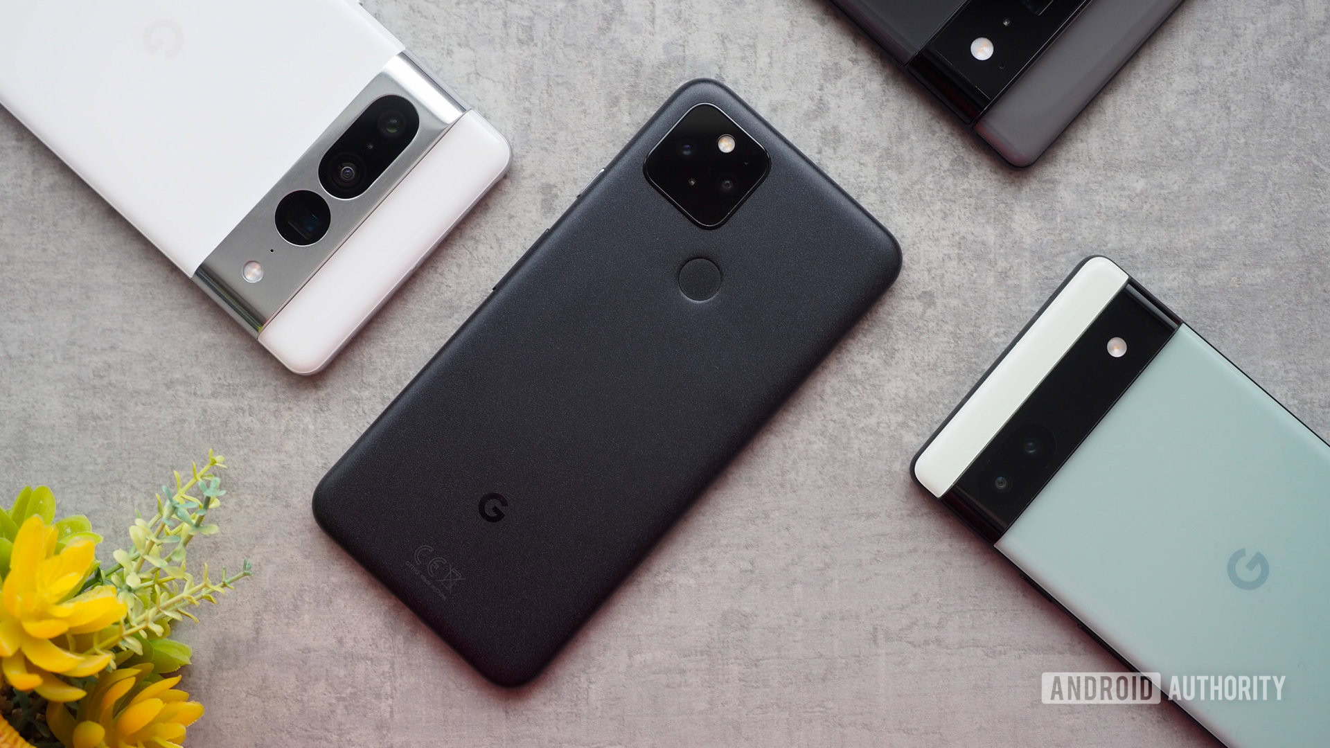 google pixel 5 plus pixel family Google Pixel 5 laying in the middle of the Pixel 6a, Pixel 6 Pro, and Pixel 7 Pro