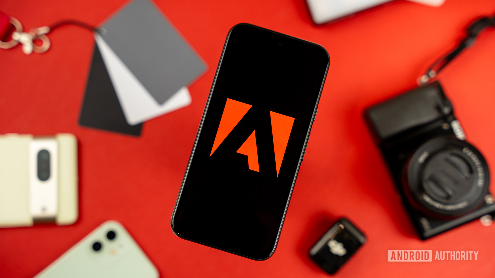 Adobe logo on smartphone, next to photography and videography products stock photo (5) Adobe logo on smartphone, next to photography and videography products stock photo (5)