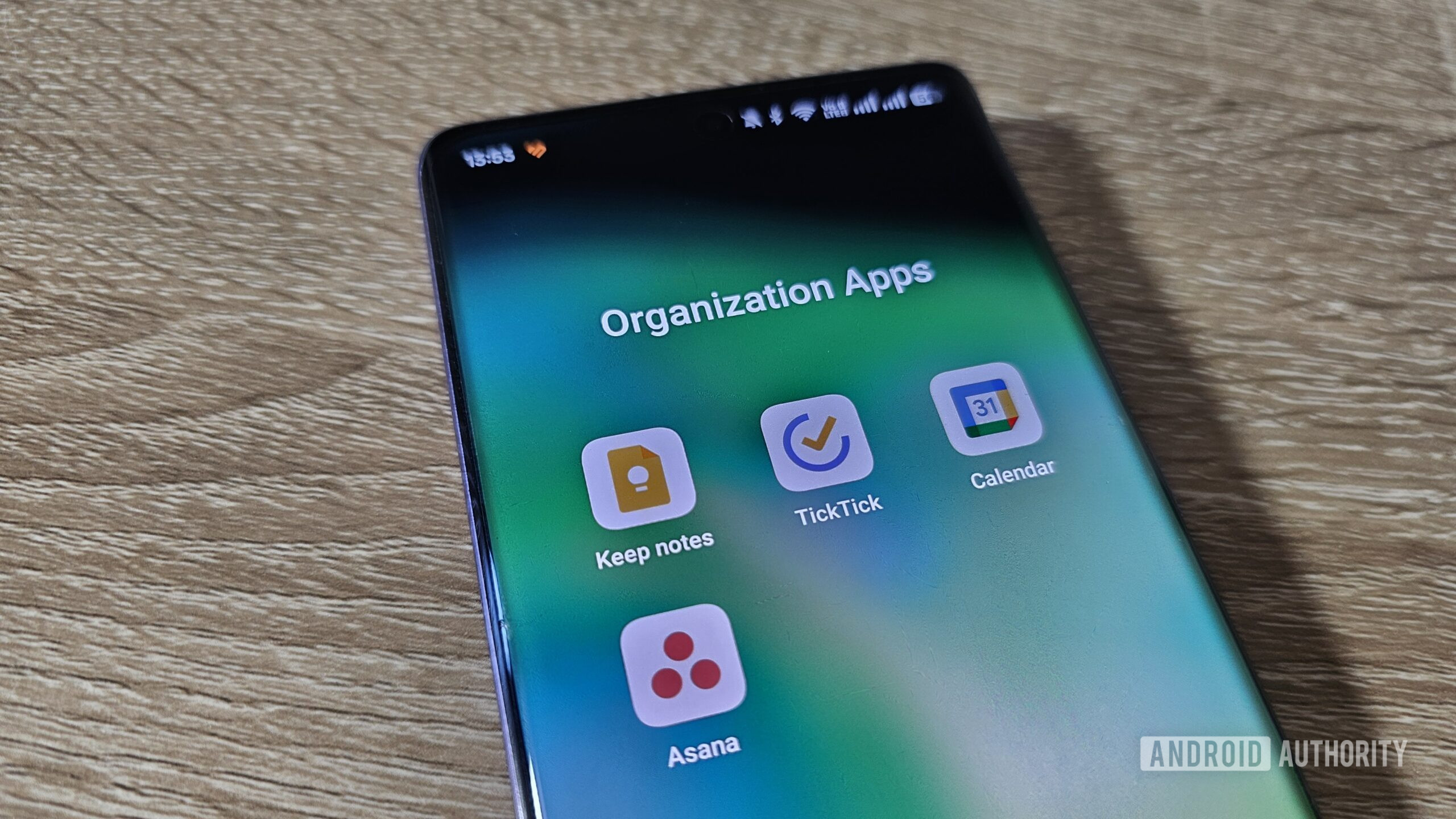 organization apps folder on smartphone on a table a smartphone with an organization apps folder on the display