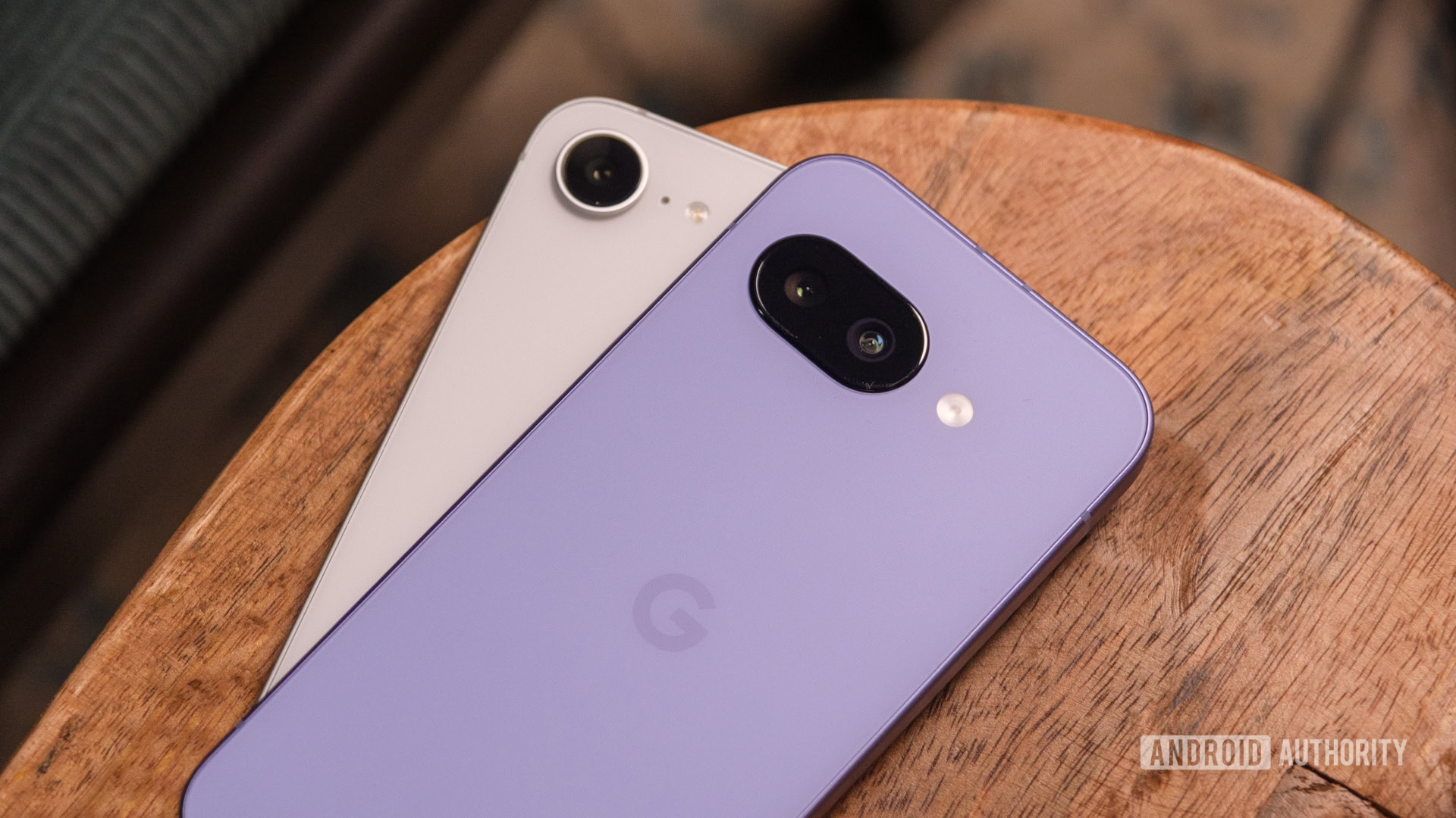 Google Pixel 9a vs iPhone 16e lying down angled Google Pixel 9a vs iPhone 16e lying down angled