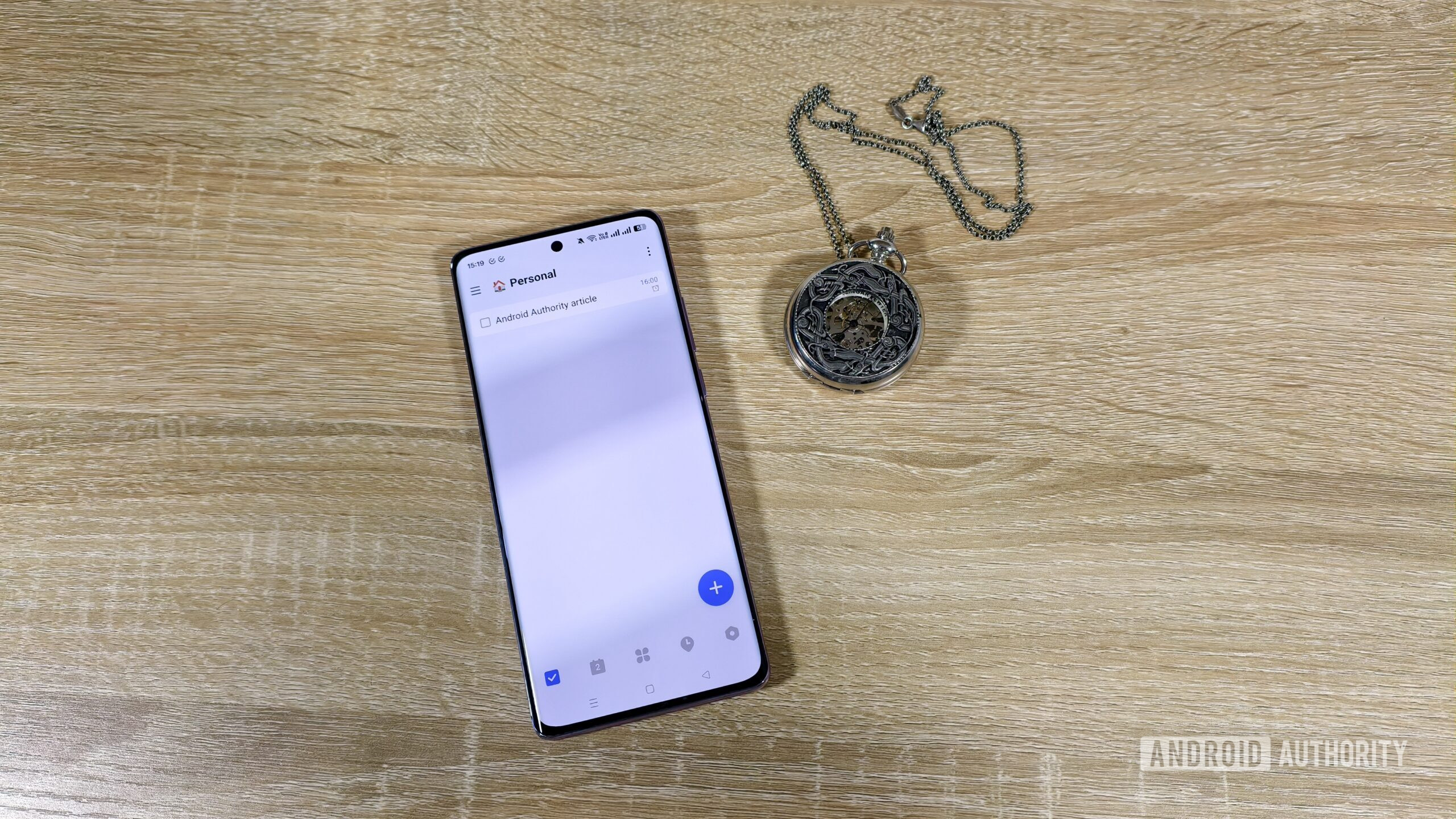 a task in the ticktick app on a smartphone next to a pocket watch a task in the ticktick app on a smartphone next to a pocket watch